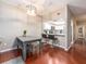 Well-lit dining area with a modern table, chairs, and bar seating looking into the kitchen at 320 Island Way # 606, Clearwater Beach, FL 33767