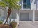 Charming condo exterior featuring a private garage, well-maintained landscaping, and a welcoming front door at 320 Island Way # 606, Clearwater Beach, FL 33767