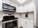 Bright kitchen featuring stainless steel appliances and white cabinets at 320 Island Way # 606, Clearwater Beach, FL 33767