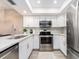 Well-lit kitchen with stainless steel appliances, white cabinetry, and granite countertops at 320 Island Way # 606, Clearwater Beach, FL 33767