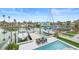 An aerial view of this home's backyard features a pool and outdoor seating near the private boat dock at 326 129Th E Ave, Madeira Beach, FL 33708