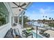 Relax on this home's covered balcony with views of the beautiful water and private boat dock at 326 129Th E Ave, Madeira Beach, FL 33708