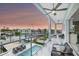 Enjoy a beautiful sunset on this home's balcony with views of the pool and private dock at 326 129Th E Ave, Madeira Beach, FL 33708