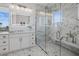 Bright bathroom featuring marble tile shower, white vanity, and a stylish, illuminated mirror for a modern touch at 326 129Th E Ave, Madeira Beach, FL 33708