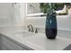 Bathroom featuring white sink and vanity, complemented by modern faucet fixtures at 326 129Th E Ave, Madeira Beach, FL 33708