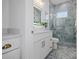 Stylish bathroom featuring blue marbled tile shower, white vanity, and framed mirror at 326 129Th E Ave, Madeira Beach, FL 33708