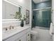 Beautiful bathroom featuring blue tiling in shower, with white vanity and sink at 326 129Th E Ave, Madeira Beach, FL 33708