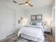 Bright bedroom featuring neutral decor, a ceiling fan, and two serene beach-themed pictures at 326 129Th E Ave, Madeira Beach, FL 33708