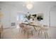 Bright dining room boasts modern chandelier, stylish chairs, and elegant decor at 326 129Th E Ave, Madeira Beach, FL 33708