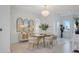 A bright and airy dining room features gold accents, a modern chandelier, and statement mirrors at 326 129Th E Ave, Madeira Beach, FL 33708