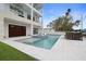 Modern home featuring a large pool, outdoor seating, balconies, and a spacious garage at 326 129Th E Ave, Madeira Beach, FL 33708