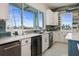 Bright kitchen features white cabinets, quartz countertops, stainless steel appliances, and a decorative tile backsplash at 326 129Th E Ave, Madeira Beach, FL 33708