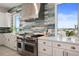 Beautiful kitchen with stainless steel appliances, custom cabinetry, and a modern range hood at 326 129Th E Ave, Madeira Beach, FL 33708