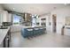 Stylish kitchen featuring white cabinets, a large island with seating, and stainless steel appliances, ideal for entertaining at 326 129Th E Ave, Madeira Beach, FL 33708
