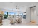 Open concept living room with kitchen in background and elevator adjacent to the living space at 326 129Th E Ave, Madeira Beach, FL 33708