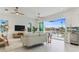 Light filled living room opens to the kitchen, and has a view of the water at 326 129Th E Ave, Madeira Beach, FL 33708