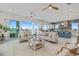 Open concept living room, dining, and kitchen with sliding glass doors, with views of the water at 326 129Th E Ave, Madeira Beach, FL 33708