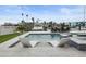 Stunning pool area with boat access, featuring built-in spa, deck seating, and clear blue water at 326 129Th E Ave, Madeira Beach, FL 33708