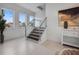 Bright, modern staircase with wood treads, white risers, stainless steel cable railing, and abundant natural light at 326 129Th E Ave, Madeira Beach, FL 33708