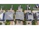 Aerial view of waterfront homes with lush landscaping, private docks, and solar panels at 460 137Th Avenue Cir, Madeira Beach, FL 33708