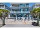Gorgeous waterfront home featuring a large patio with lounge chairs and a serene view of the waterway at 460 137Th Avenue Cir, Madeira Beach, FL 33708