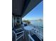 Relaxing balcony view with outdoor seating overlooking the serene waterfront, ideal for enjoying scenic vistas at 460 137Th Avenue Cir, Madeira Beach, FL 33708