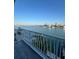 Stunning water view from this outdoor balcony, complete with wood decking and a white railing at 460 137Th Avenue Cir, Madeira Beach, FL 33708