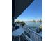 Balcony with table and water views from waterfront home at 460 137Th Avenue Cir, Madeira Beach, FL 33708