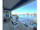 Balcony view of waterway with seating, white railings, and blue skies at 460 137Th Avenue Cir, Madeira Beach, FL 33708