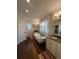 Bright bathroom featuring a clawfoot tub, dark hardwood flooring, and custom cabinets at 460 137Th Avenue Cir, Madeira Beach, FL 33708