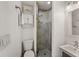 Neutral bathroom featuring a glass-enclosed shower, toilet, and vanity with great lighting at 460 137Th Avenue Cir, Madeira Beach, FL 33708