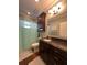 Well-lit bathroom with a granite countertop vanity, classic fixtures, and a shower-tub combo at 460 137Th Avenue Cir, Madeira Beach, FL 33708