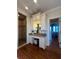 Vanity area, with a walk-in shower, wood flooring and ample cabinet storage space at 460 137Th Avenue Cir, Madeira Beach, FL 33708