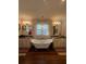 Bathroom with a claw foot tub, double sinks and chandelier at 460 137Th Avenue Cir, Madeira Beach, FL 33708