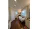 Bright bathroom featuring a clawfoot tub, dark hardwood flooring, and custom cabinets at 460 137Th Avenue Cir, Madeira Beach, FL 33708