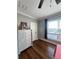 Cozy bedroom featuring hardwood floors, natural light from the window, and a decorative dresser at 460 137Th Avenue Cir, Madeira Beach, FL 33708