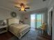 Bright bedroom with water views, a sliding glass door to the balcony, and comfortable decor and furnishing at 460 137Th Avenue Cir, Madeira Beach, FL 33708