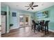 Dining area features coastal decor, wood-look flooring, and sliding glass doors to the outdoor area at 460 137Th Avenue Cir, Madeira Beach, FL 33708