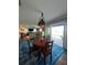 Dining area with industrial-style lighting fixture, round table and waterfront views at 460 137Th Avenue Cir, Madeira Beach, FL 33708