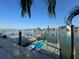 Picturesque waterfront view featuring a dock with kayaks and boat lifts, blending recreation and serene scenery at 460 137Th Avenue Cir, Madeira Beach, FL 33708