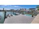 Modern boat dock featuring multiple boat lifts and a large boat, offering easy water access and stunning views at 460 137Th Avenue Cir, Madeira Beach, FL 33708