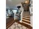 Inviting entryway with hardwood floors, staircase, and views of the living room and outdoor living area at 460 137Th Avenue Cir, Madeira Beach, FL 33708