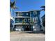 Beautiful blue two-story home with a double garage, well-maintained landscaping, and a welcoming entrance at 460 137Th Avenue Cir, Madeira Beach, FL 33708