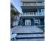A blue two-story home with a walkout and pool at 460 137Th Avenue Cir, Madeira Beach, FL 33708