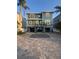 Charming two-story home with a paver driveway, two-car garages, and lush landscaping at 460 137Th Avenue Cir, Madeira Beach, FL 33708