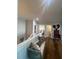 Upper hallway featuring hardwood floors and a quaint bench with assorted pillows at 460 137Th Avenue Cir, Madeira Beach, FL 33708