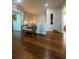 Hallway features hardwood floors and a cozy sitting area with a turtle statue and custom lighting at 460 137Th Avenue Cir, Madeira Beach, FL 33708