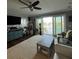 Beautiful living room with a fan, nice rug and water view through a large sliding glass door at 460 137Th Avenue Cir, Madeira Beach, FL 33708