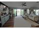 Open-concept living room with hardwood floors and sliding glass doors with a water view at 460 137Th Avenue Cir, Madeira Beach, FL 33708
