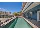 Serene backyard oasis with a sleek pool, a private dock, and beautiful views of the intercoastal and nearby cityscape at 460 137Th Avenue Cir, Madeira Beach, FL 33708